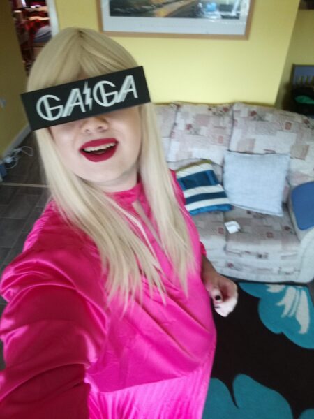 Gerraint dressed as Lady Gaga in a blonde wig and black Gaga glasses.