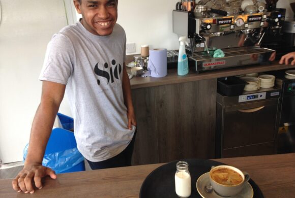 Young man working in a cafe